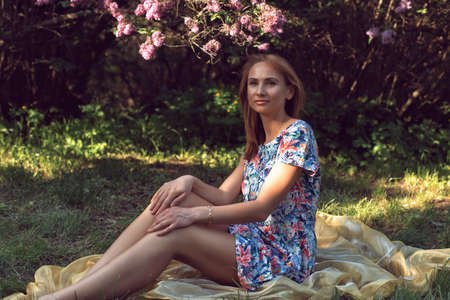 Walk with a young woman in the lilac flowering seasonの写真素材