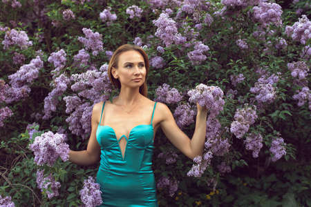 Walk with a young woman in the lilac flowering seasonの写真素材