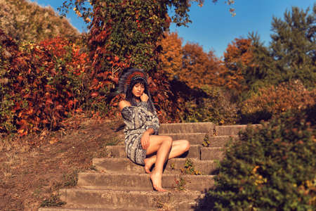 Girl in the park in an American headdressの写真素材
