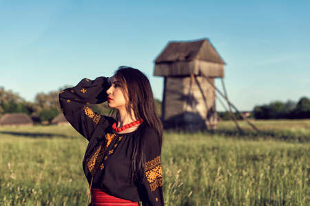 Young girl among old wooden buildings