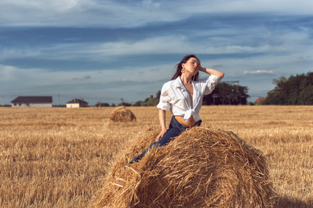 Photoshoot of a girl in a wheat fieldの写真素材