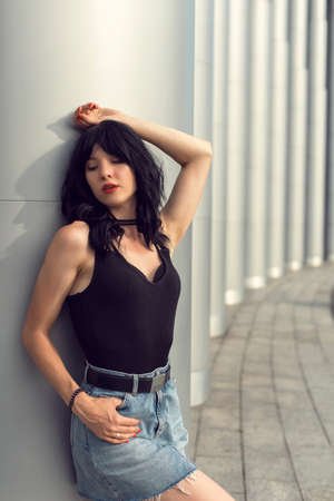 Brunette near the building with columnsの写真素材