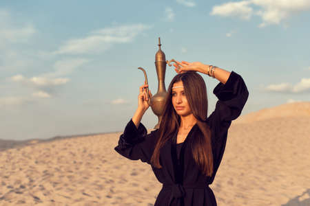 Muslim girl in the summer desertの写真素材