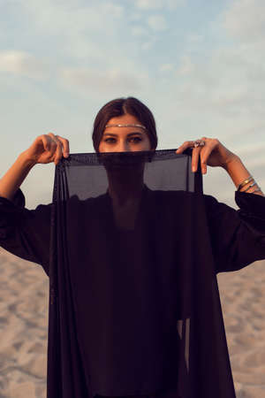 Muslim girl in the summer desertの写真素材