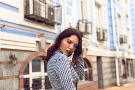 Walking with a brunette in a summer cityの写真素材