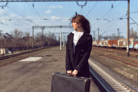 Young woman at the old train stop