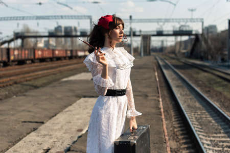 Young woman at the old train stop