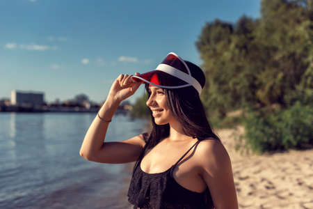 Girl on the sand near the riverの写真素材