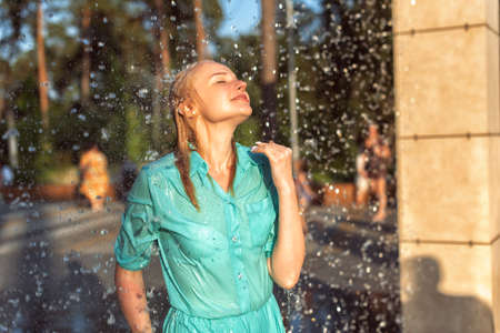 Mature blonde in the summer in the fountainの写真素材