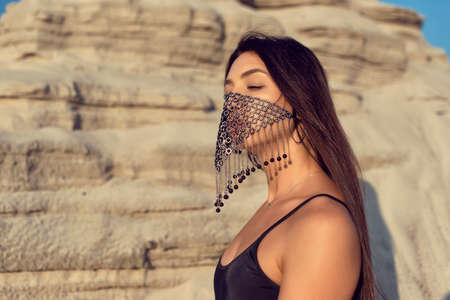 Brunette on vacation in a one piece swimsuitの写真素材