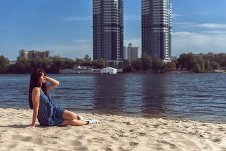 Young brunette in denim dressの写真素材