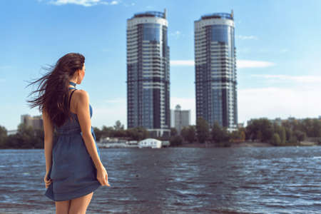 Young brunette in denim dressの写真素材
