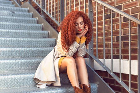 Redhead curly woman in the city