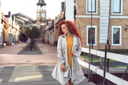 Redhead curly woman in the cityの写真素材