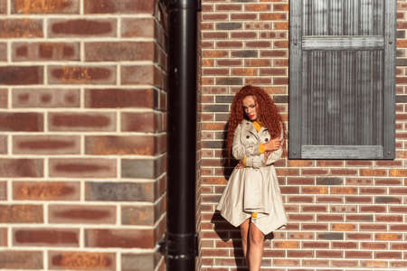 Redhead curly woman in the cityの写真素材