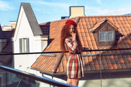 Redhead curly woman in the cityの写真素材