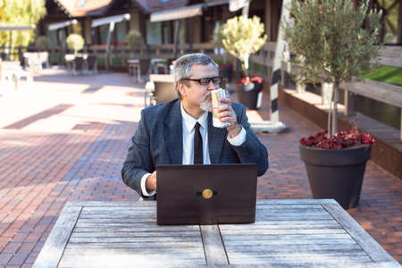 Businessman on the street and making money on bitcoinの写真素材