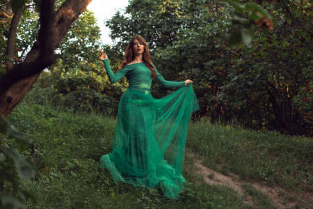 Young woman in green dress in the park