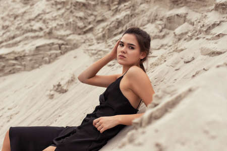 Tanned brunette in the sand dunes