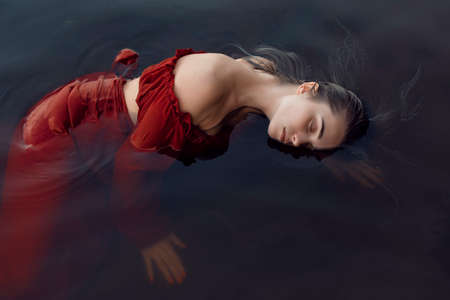 Blonde girl bathes in a summer lake