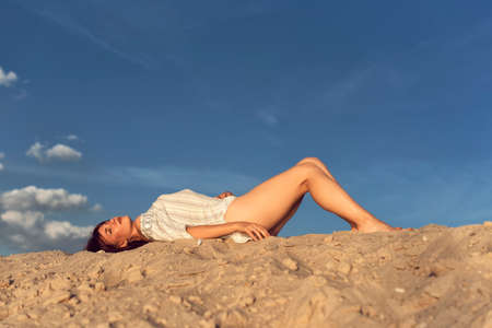 Young brunette woman on a sunny summer dayの写真素材