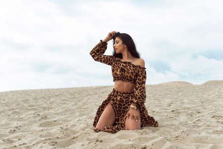 Girl in the dunes on a cloudy day