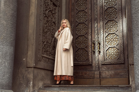 Young blonde woman in autumn cityの写真素材