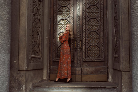 Young blonde woman in autumn city