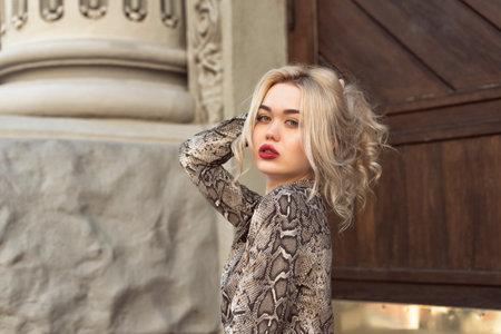 Young blonde woman in autumn city