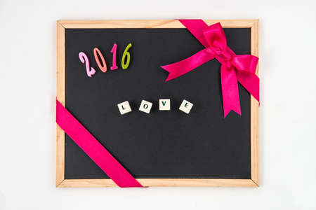 Blank blackboard with year decoration "2016 love". white backgroundの写真素材