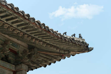 Traditional korea roof decoration. blue sky and Colorful structuresの写真素材