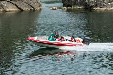 Chungcheongbuk-do, South Korea - August 29, 2016: Powerful and sleek motor boat is cruising along an island on River of the river, South Koreaのeditorial素材
