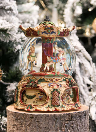 Christmas decoration carousel horses, Christmas presents on wooden table.の写真素材