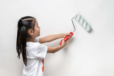 Cute asian girl holding paint rollerの写真素材