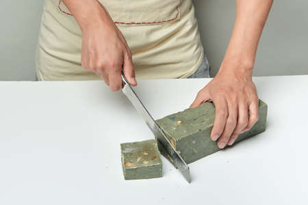 man cutting a handmade soap with a knifeの写真素材