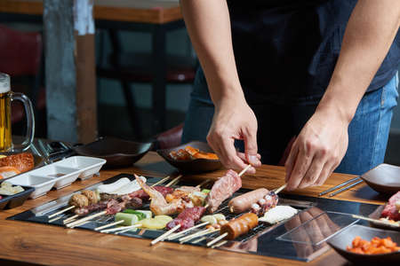 Various skewer foods, men's handsの写真素材