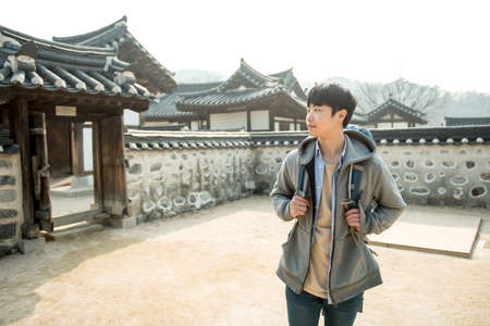 Young man traveling in Koreaの写真素材