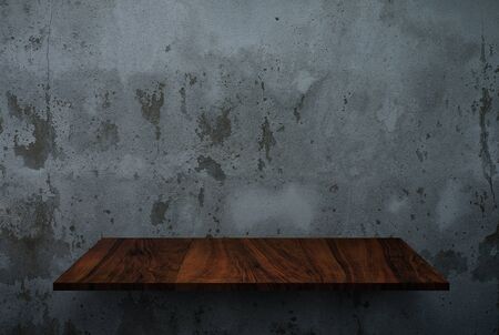 Empty wooden shelf on concrete wall textureの写真素材