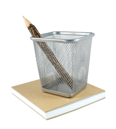 Wooden pencil in basket with bookの写真素材