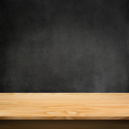 Wood table with dark concrete texture backgroundの写真素材
