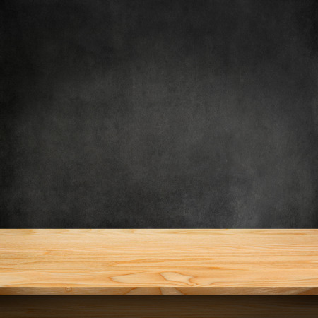 Wood table with dark concrete texture background