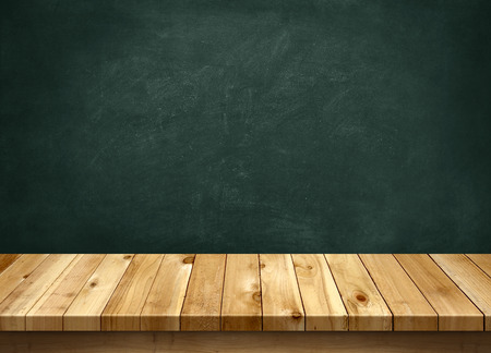 Wood table with blackboard backgroundの写真素材