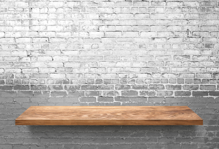 Wooden shelf on white brick wallの写真素材