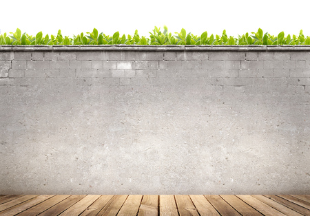 Wooden floor and concrete wall on green leaves backgroundの写真素材