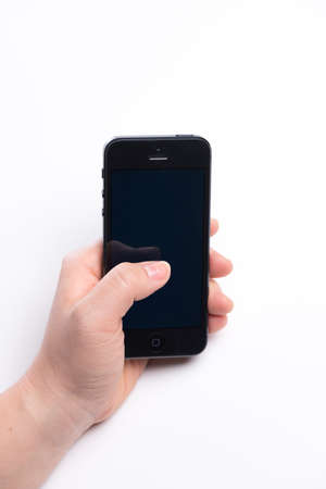 Paris, France - November 11, 2015: Woman holding in the hand an  black iPhone 6 isolated on a white backgroundのeditorial素材