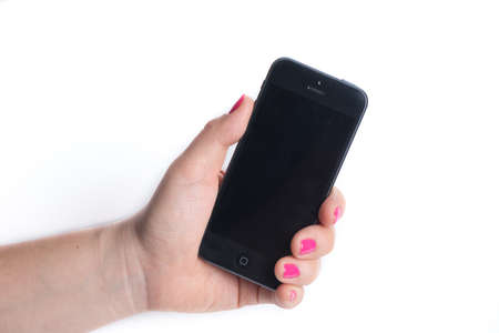 Paris, France - November 11, 2015: Woman holding in the hand an  black iPhone 6 isolated on a white backgroundのeditorial素材