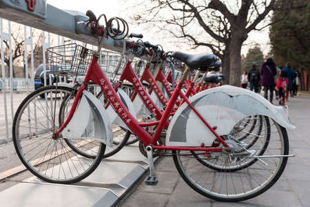 Beijing,  China December 13th 2016: Public bikes renting station with red and white bikes ready to be rentedのeditorial素材