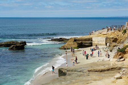 Beachgoers enjoying a beautiful sunny day at La Jolla Cove in San Diego, California, USA. August,...
