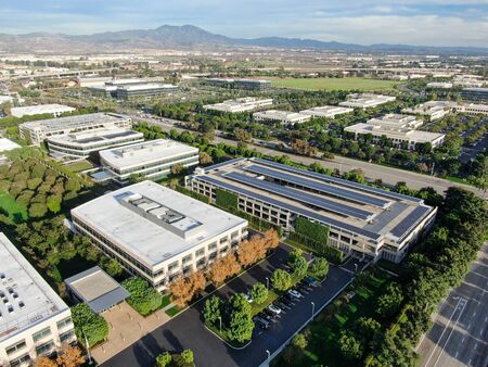 Aerial view of business and finance district with new office building surrounded by parking and...