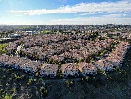 Aerial view of upper middle class neighborhood with identical residential subdivision houses during sunny day in Chula Vista, California, USA.の写真素材